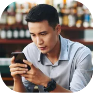 Deriv affiliate partner checking earnings on mobile phone through partner programme app