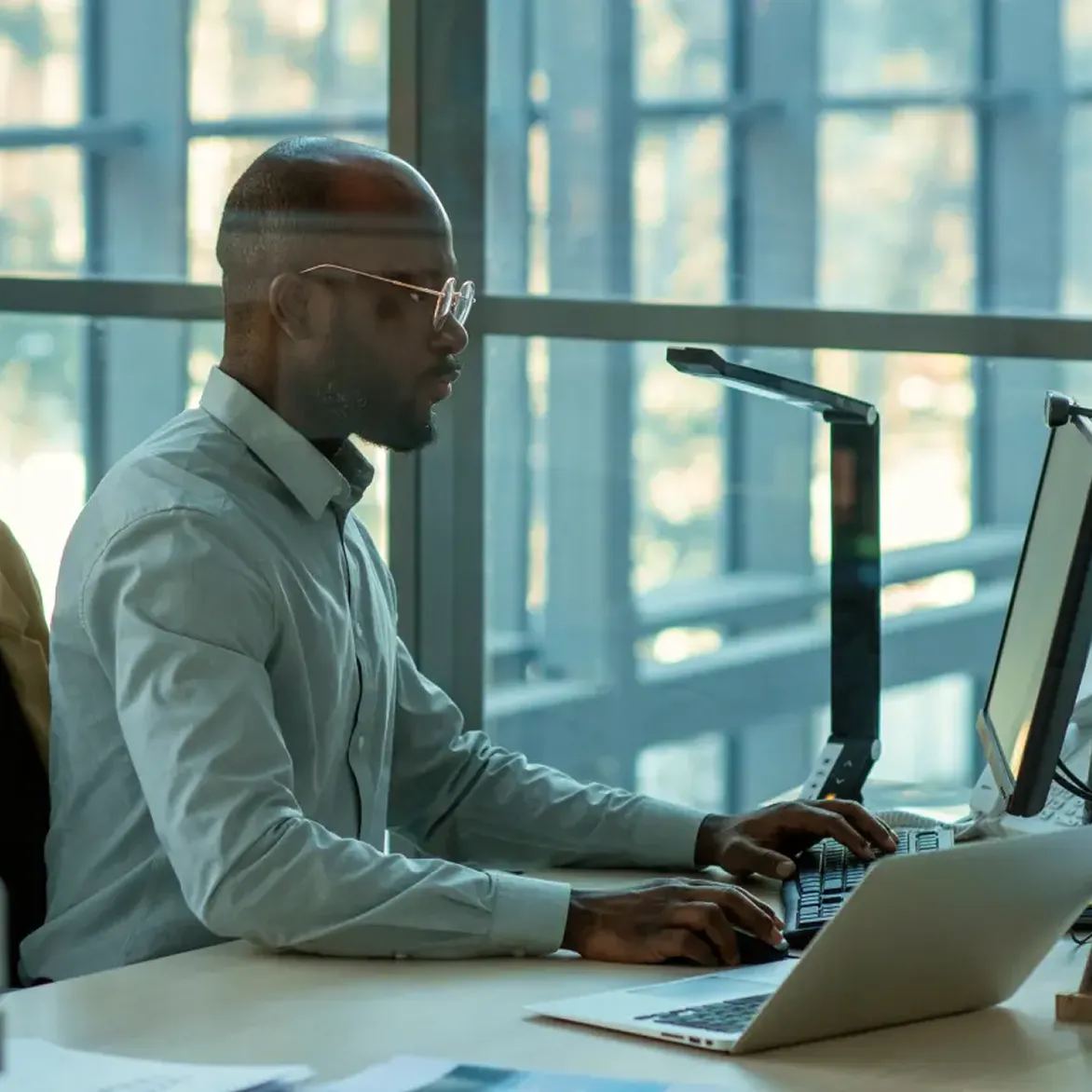 Deriv affiliate partner working from home office desk on computer to grow online trading commissions