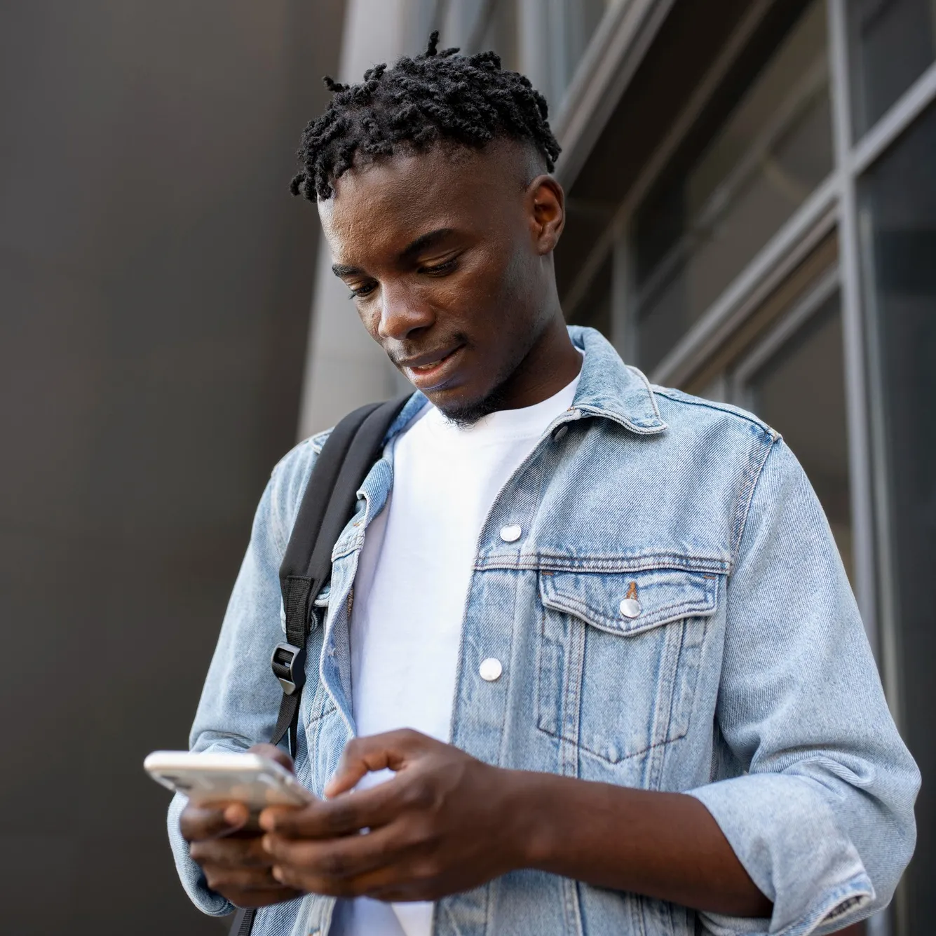 Young man checking the Deriv MT5 trading app demo account on his phone