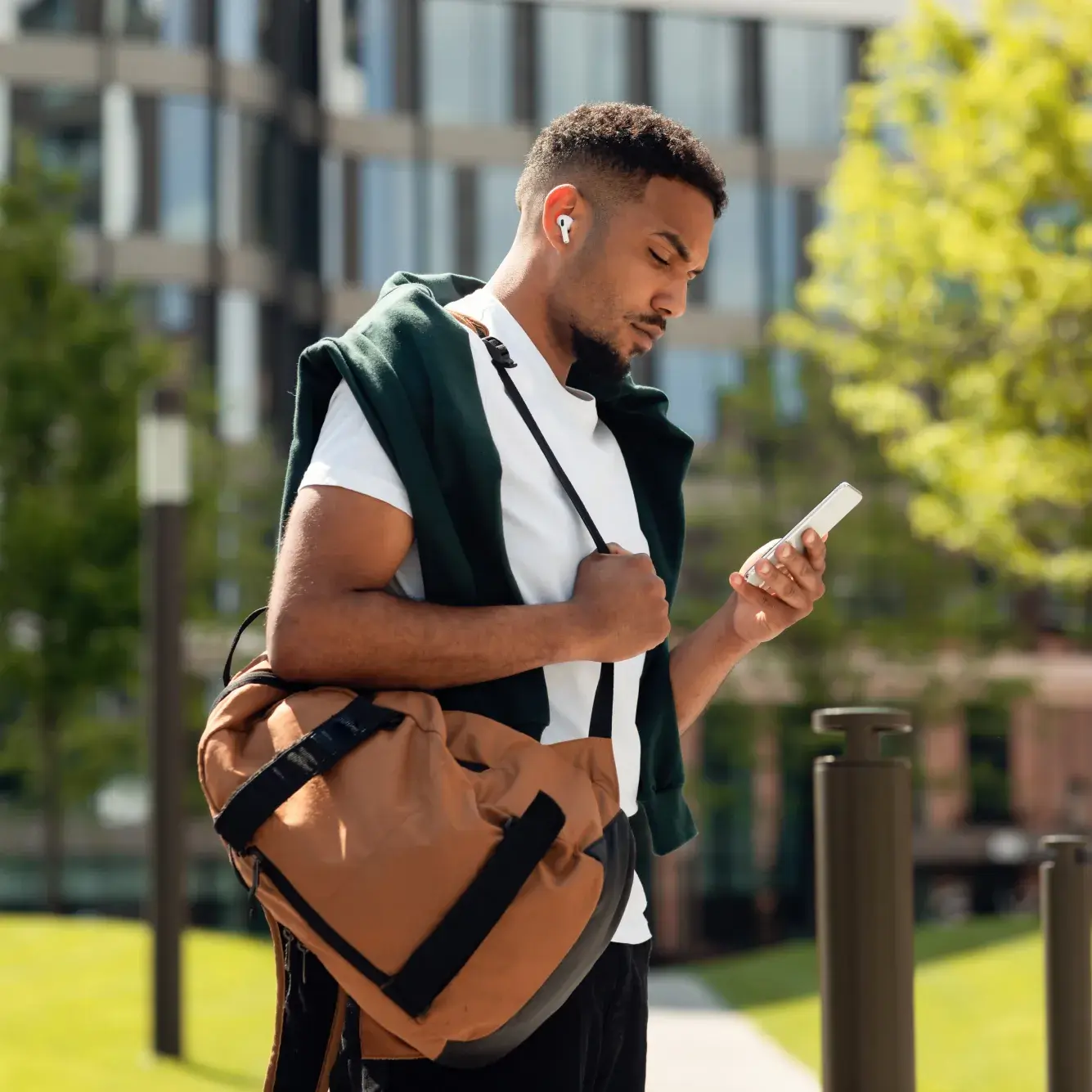 Trader checking US Tech 100 prices on mobile trading platform
